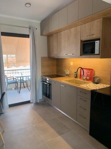 a kitchen with a sink and a stove top oven at Attic View Palatia in Néa Palátia