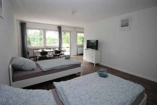 a living room with a couch and a table at Cozy Apartment in Remscheid in Radevormwald