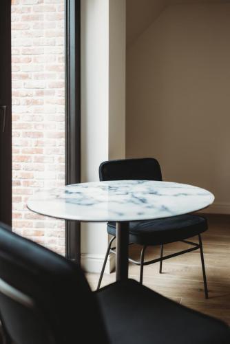 a table and two chairs in a room at Eikenhoef in Lommel