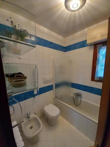 a bathroom with a toilet and a tub and a sink at Vacanza nella Natura in Punta Ala