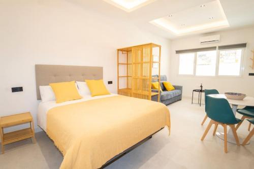 ein Schlafzimmer mit einem großen Bett mit gelben Kissen in der Unterkunft Center Medina Suite in Granada