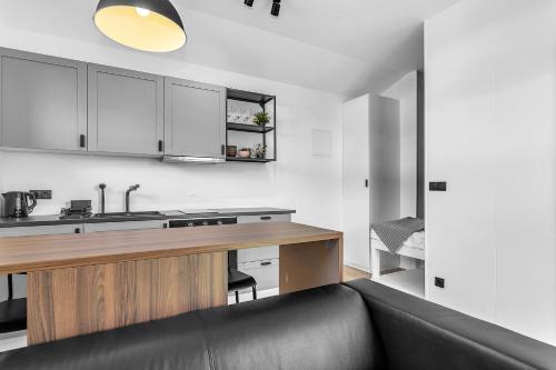 a living room with a couch and a kitchen at Cozy Haven in Hafnarfjörður in Hafnarfjördur