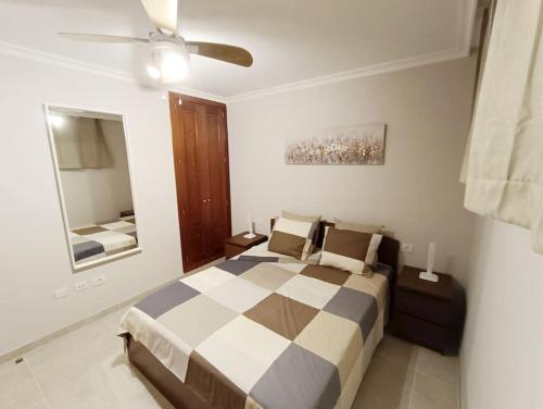 a bedroom with a bed and a ceiling fan at Apartamento Idaira Sun in Los Cristianos