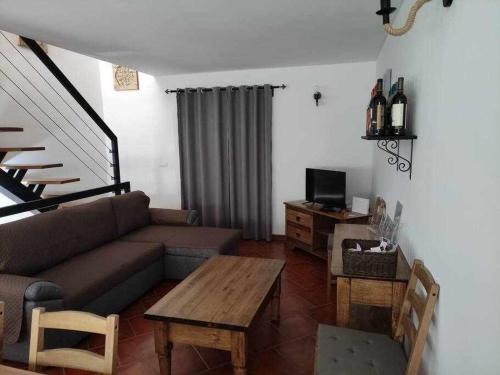 a living room with a couch and a table at Di&Ana II - Alojamento Vila Viçosa in Vila Viçosa
