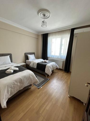 a bedroom with two beds and a window at anka suiteapart in Bostancı