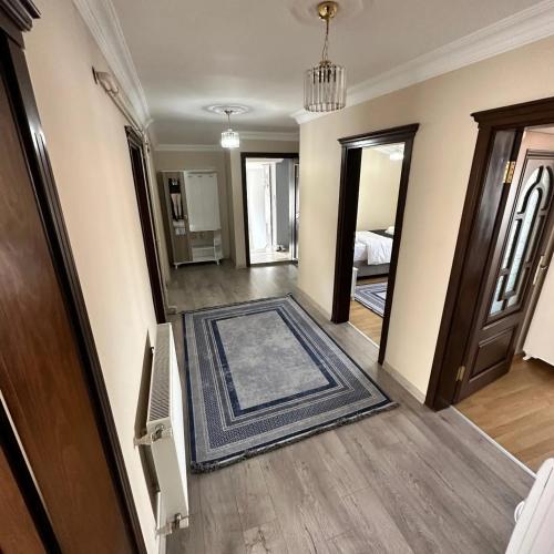 an empty room with a door and a room with a rug at anka suiteapart in Bostancı