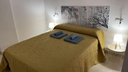 um quarto com uma cama com duas toalhas em Apartamento PUERTO em Mazagón