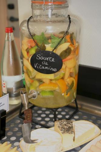 a jar filled with vegetables and cheese on a table at ibis Saint-Lô in Saint Lo
