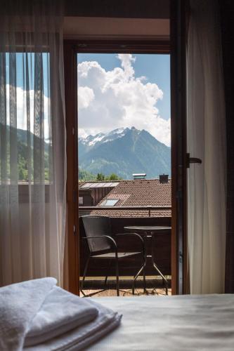 a bedroom with a bed and a view of a mountain at Hotel Post Fusch in Fusch an der Glocknerstraße