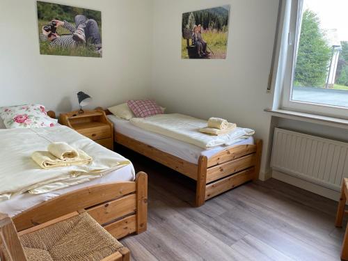 two twin beds in a room with a window at Apartment Haus Aktiv Panorama in Winterberg