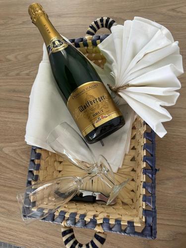 a bottle of wine in a basket on a table at GITE MA MAISON in Kintzheim