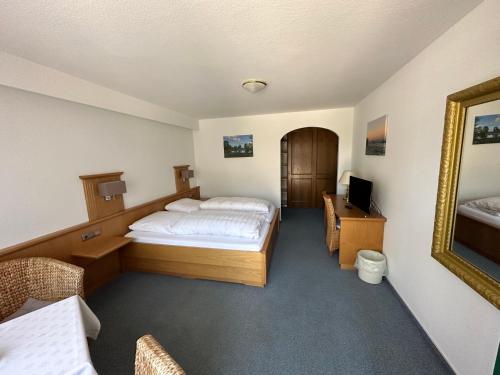 a hotel room with a bed and a mirror at Gasthof Menke in Niederhaverbeck