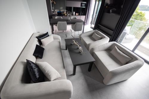 a living room with two couches and a table at Hotel Mazuria Country & SPA in Mrągowo
