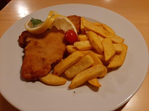 a plate of food with fish and french fries at Hotel Landgasthof Frankenstern in Gößweinstein