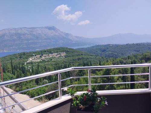 a balcony with a view of a mountain at Apartman Marija in Korčula
