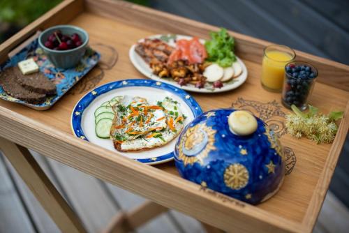 a wooden table with plates of food on it at Ennu’s hut in Loksa