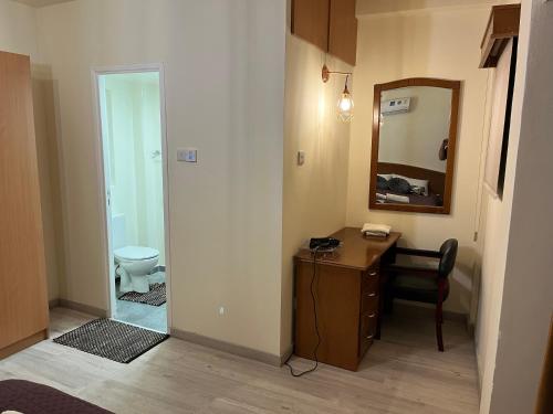 a bathroom with a desk and a mirror and a toilet at Nicosia Venetian Walls in Nicosia