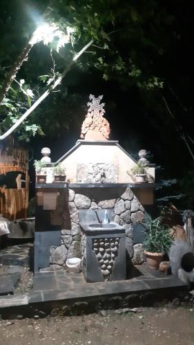 a stone monument with a sink in a yard at Luiza Guest House in Areni