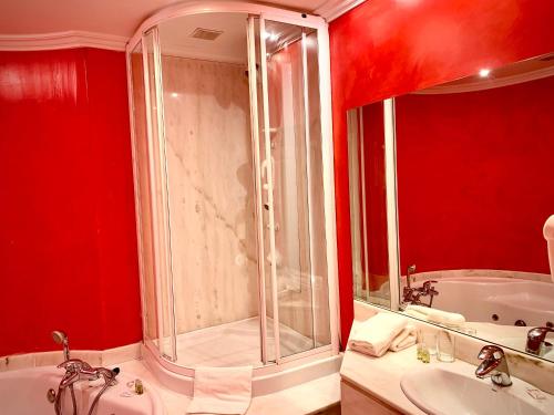 a bathroom with a shower and a sink and a tub at Marina de Campios in Comillas