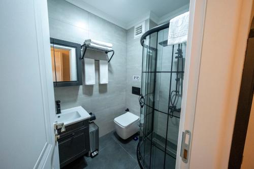 a bathroom with a shower and a toilet and a sink at Solomon's Mansion Hotel Istanbul in Istanbul