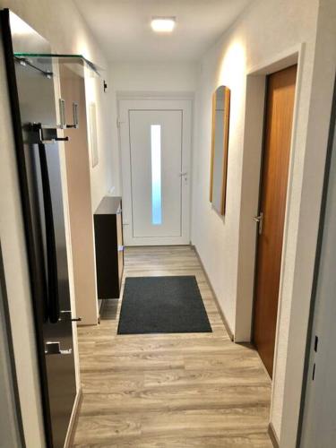 a corridor of a hallway with a door and a rug at Schöne Ferienwohnung direkt am Neckar in Deißlingen