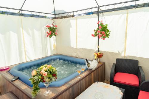a jacuzzi tub in a tent with flowers at Boutique Guest House 'Sofia' in Nesebar