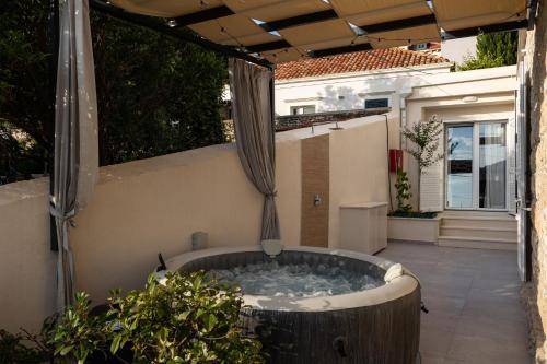 a jacuzzi tub sitting on the patio of a house at Apartments aMare in Dubrovnik