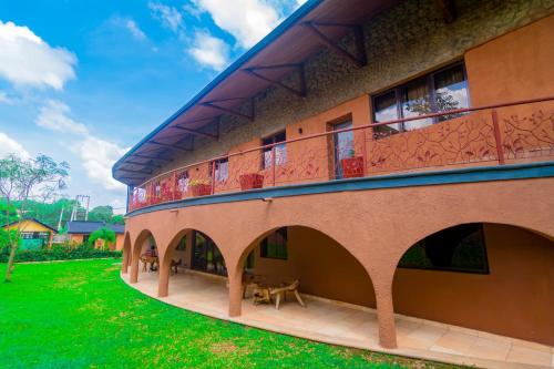 an external view of a building with a balcony at Trois Ore Residences & Green Earth Bistro in Ibadan