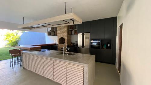 a kitchen with a island in the middle of a room at Villa Parazinho in Paracuru