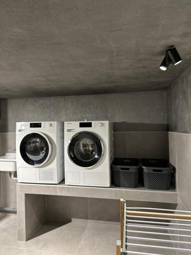 two washing machines sitting on a shelf in a room at Apart Walser in Seefeld in Tirol