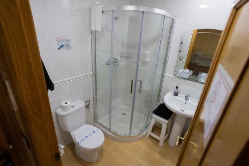 a bathroom with a shower and a toilet and a sink at Hotel Beatriz in Burriana