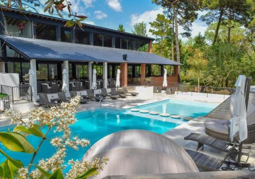 a swimming pool with chairs and a house at Carilo Hills by bund in Carilo