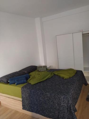 a bedroom with a bed with a green comforter at Appartment as a Service - Lo Mejor en Malaga Centro - Look no Further and Just Book in Málaga