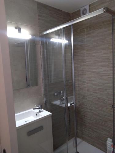 a bathroom with a shower and a sink and a mirror at Appartment as a Service - Lo Mejor en Malaga Centro - Look no Further and Just Book in Málaga