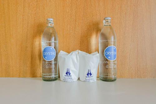 three bottles of water sitting on top of a counter at Hadthong Hotel in Prachuap Khiri Khan