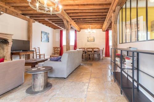 a living room with a couch and a table at La Garenne in Bretenière