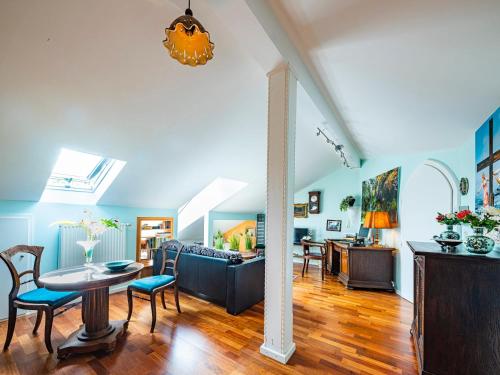 a living room with a couch and a table and chairs at Homely Stay in a romantic lodging with sauna&gym in Münsing am Starnberger See