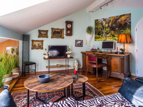 a living room with a table and a desk at Homely Stay in a romantic lodging with sauna&gym in Münsing am Starnberger See