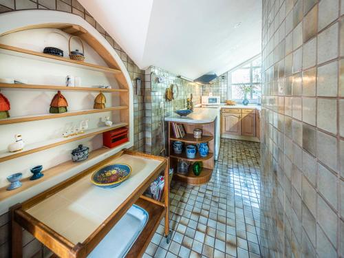 a kitchen with a sink and shelves in a room at Homely Stay in a romantic lodging with sauna&gym in Münsing am Starnberger See