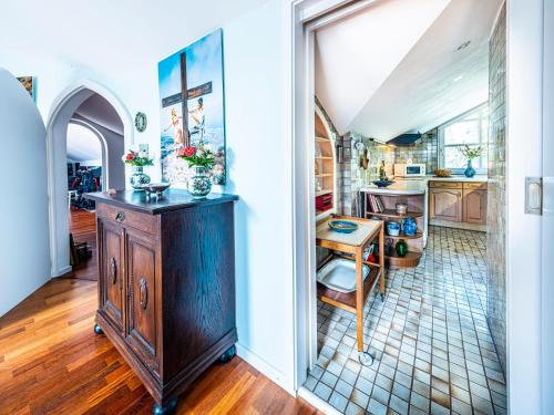 a kitchen with a wooden cabinet in a room at Homely Stay in a romantic lodging with sauna&gym in Münsing am Starnberger See