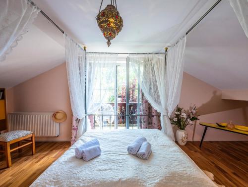 a bedroom with a bed with two pillows on it at Homely Stay in a romantic lodging with sauna&gym in Münsing am Starnberger See