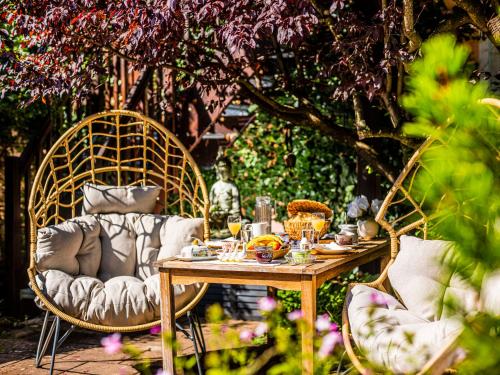 a table and chairs with food and drinks on it at Homely Stay in a romantic lodging with sauna&gym in Münsing am Starnberger See