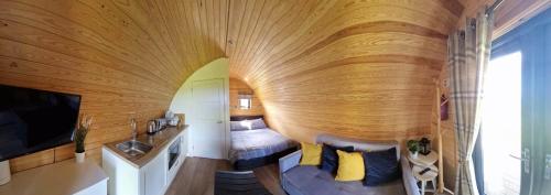 a circular room with a bed and a sink in a room at The Travellers Rest in Newquay