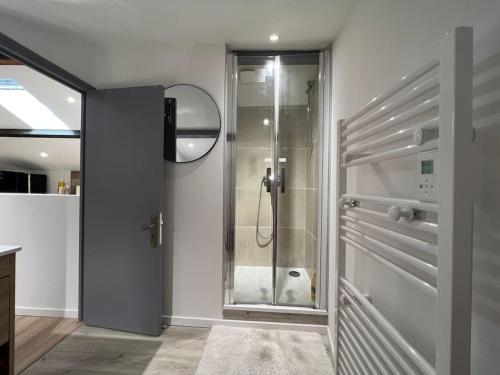 a bathroom with a shower with a glass door at Kiss Cool - Loft en centre ville in Saint-Dizier