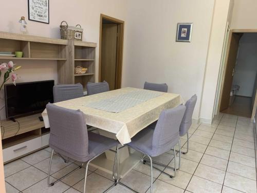 a dining room with a table and chairs at Apartments Lea in Orebić