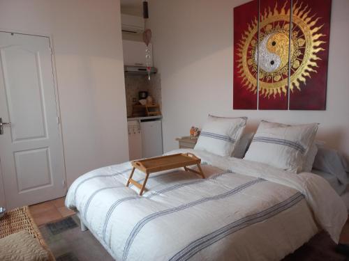 sypialnia z dużym łóżkiem z drewnianym stołkiem w obiekcie Studio les étoiles d'Azur w mieście Aspremont