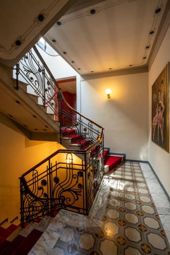 a spiral staircase in a building with a red railing at Hotel Laurin in Salò