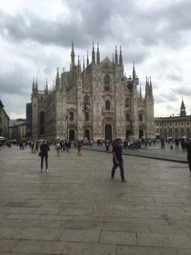 a group of people standing in front of a cathedral at Arco della Pace Corso Sempione 12 in Milan