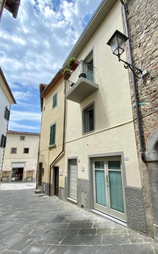 a building with a balcony on the side of it at Casa Marina in Radda in Chianti
