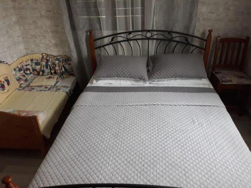 a bedroom with two twin beds and a table at Μονοκατοικία Kathrin in Nea Kalikratia